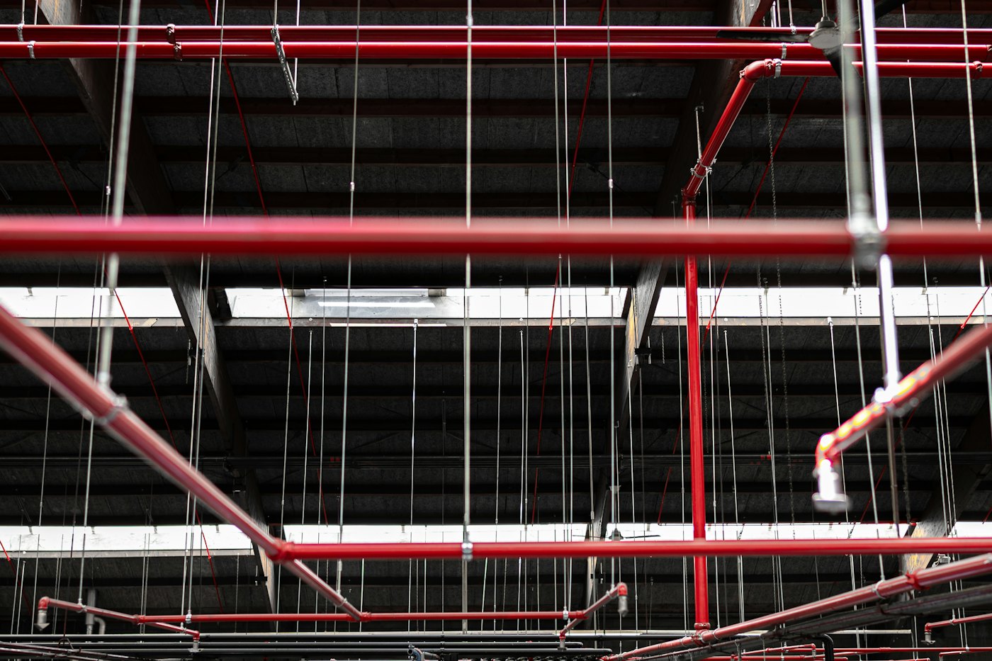 Red fire sprinkler pipework on a ceiling
